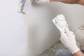 Worker plastering wall with putty knife indoors, closeup Royalty Free Stock Photo