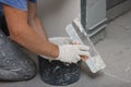 Worker plastering wall with putty knife indoors, closeup Royalty Free Stock Photo