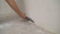 Work aligns with a spatula wall. Worker plastering a wall with a spatula Royalty Free Stock Photo