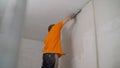 Work aligns with a spatula wall. Worker plastering the walls with a spatula Royalty Free Stock Photo