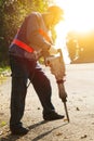 Worker with pneumatic hammer drill equipment