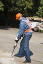 Worker with pneumatic hammer drill equipment