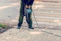 Worker with pneumatic hammer drill equipment. Road repairing works with jackhammer Royalty Free Stock Photo