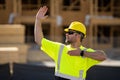 worker pointing out. Builder in a hard hat working on a construction project at a site. A builder worker in a helmet Royalty Free Stock Photo