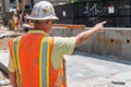 worker pointing at a slab alignment issue, adjustments needed