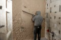 Worker polishes the wall after machine plaster. Walls with gypsum plaster or cement plaster. Plasterer operating man