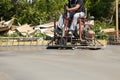 Worker polishing fresh concrete slab with a ride on power trowel machine Royalty Free Stock Photo