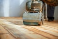 Worker polishing parquet floor with grinding machine Royalty Free Stock Photo