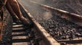 A worker positioned along a long chute manually picks out rocks and debris from chunks of coal as they move down the Royalty Free Stock Photo