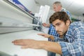 Worker at post press finishing line machine Royalty Free Stock Photo