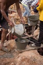 Worker pouring concrete from pail bucket Royalty Free Stock Photo