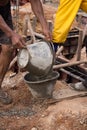 Worker pouring concrete from pail bucket Royalty Free Stock Photo