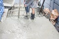 Worker pouring concrete works