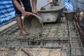 Worker pouring concrete works