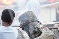 Worker pouring molten metal to casting Buddha statue