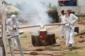 Worker pouring molten metal to casting Buddha statue