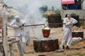 Worker pouring molten metal to casting Buddha statue