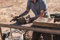 Worker pours the mixture of mud, sand and sawdust over molds for making bricks Royalty Free Stock Photo