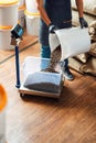 A worker pours roasted coffee beans from a bucket into a tray on a weighing scale