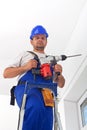 Worker with power drill standing on ladder Royalty Free Stock Photo