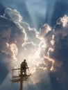 Worker on Power Line Observes Dramatic Sky Filled With Clouds and Sunlight During Late Afternoon Hours Royalty Free Stock Photo