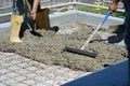 Worker powering cement in the driveway construction site Royalty Free Stock Photo