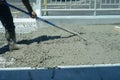 Worker powering cement in the driveway construction site Royalty Free Stock Photo