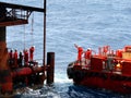 The worker prepare swing rope to move from platform to supply boat