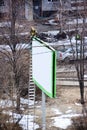 Worker prepares billboard to installing new advertisement. Industrial climber working on a ladder - placing