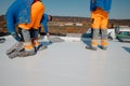 Worker prepares geotextile for the roof, covers it with synthetic PVC membrane