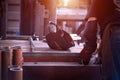 Worker prepares iron pipes for welding