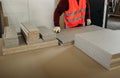 A worker prepares PVC furniture boards for packaging