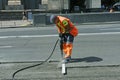 Worker preparing lay for asphalting the road on the street using pneumatic road breaker.