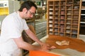 Worker preparing orthopedic insoles for a patient on his workshop