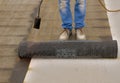 Worker preparing part of bitumen roofing felt roll Royalty Free Stock Photo