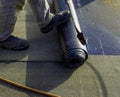 Worker preparing part of bitumen roofing felt roll Royalty Free Stock Photo