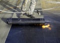 Worker preparing part of bitumen roofing felt roll Royalty Free Stock Photo