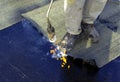 Worker preparing part of bitumen roofing felt roll Royalty Free Stock Photo