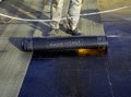 Worker preparing part of bitumen roofing felt roll Royalty Free Stock Photo