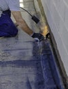 Worker preparing part of bitumen roofing felt roll Royalty Free Stock Photo