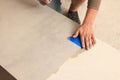 Worker preparing tile for installation indoors, closeup