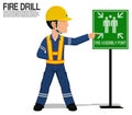 A worker is presenting the fire assembly point sign Royalty Free Stock Photo