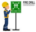 A worker is presenting the fire assembly point sign Royalty Free Stock Photo