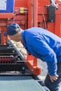 Worker pressing buttons on CNC machine control board in factory. Worker works at a woodworking enterprise. vertical photo Royalty Free Stock Photo