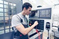 Worker pressing buttons on CNC machine Royalty Free Stock Photo