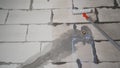 A male worker paints the wall with a roller for better adhesion of the plaster. The worker primes the wall with a roller Royalty Free Stock Photo