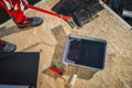 Worker Priming Plywood Roof before EPDM Membrane Installation