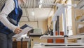 Worker of printing with a stack of paper at the machine