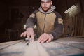 A worker processes a Board on a woodworking machine Royalty Free Stock Photo