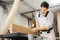 Worker processes board on woodworking machine Royalty Free Stock Photo